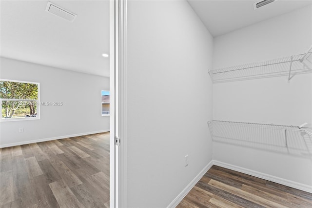 walk in closet featuring wood finished floors and visible vents