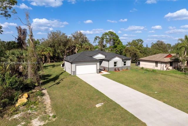 view of front of property with concrete driveway, an attached garage, a front lawn, and stucco siding