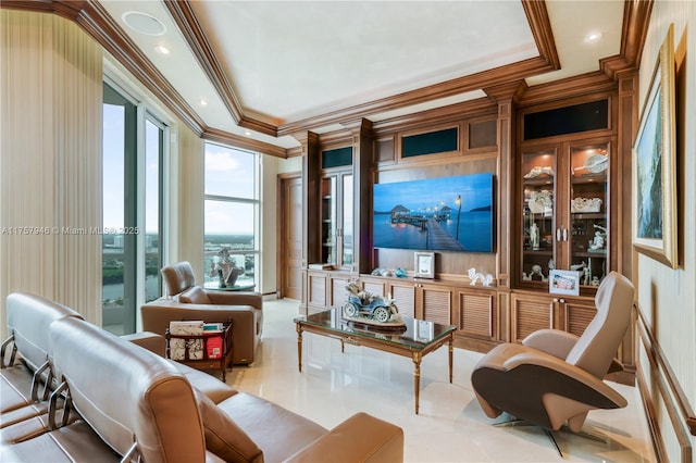 living area with ornamental molding, a raised ceiling, and recessed lighting