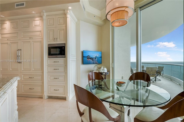 dining space featuring ornamental molding and visible vents