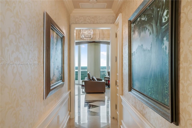 hallway with visible vents, crown molding, and wallpapered walls