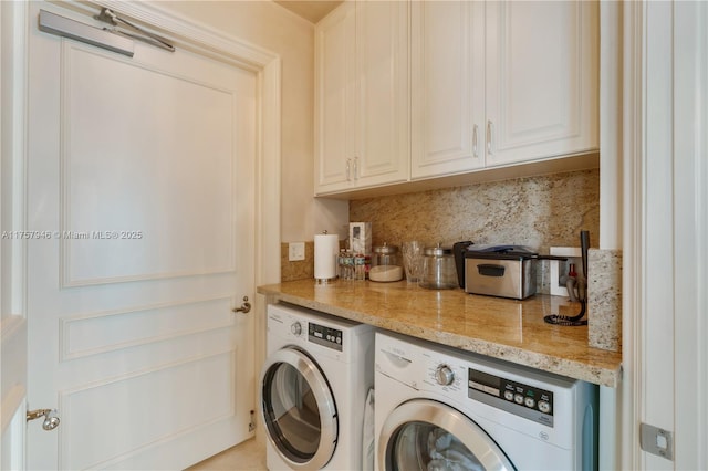 laundry area with cabinet space and washing machine and clothes dryer