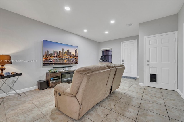 living room with light tile patterned floors, baseboards, visible vents, and recessed lighting