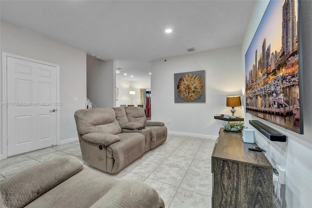 living room featuring baseboards, light tile patterned floors, visible vents, and recessed lighting