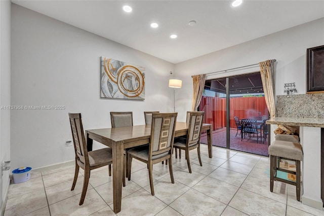 dining space featuring light tile patterned floors and recessed lighting