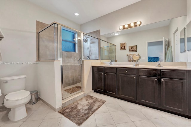 bathroom featuring double vanity, baseboards, toilet, tile patterned floors, and a shower stall