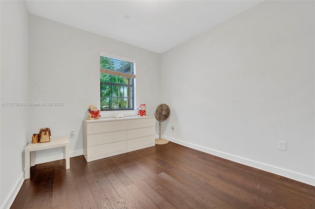 interior space featuring dark wood-style floors and baseboards