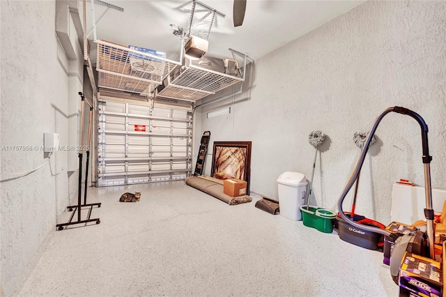 garage with a textured wall and a garage door opener