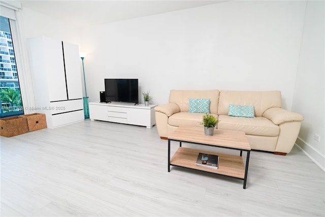 living room featuring light wood-style floors and baseboards