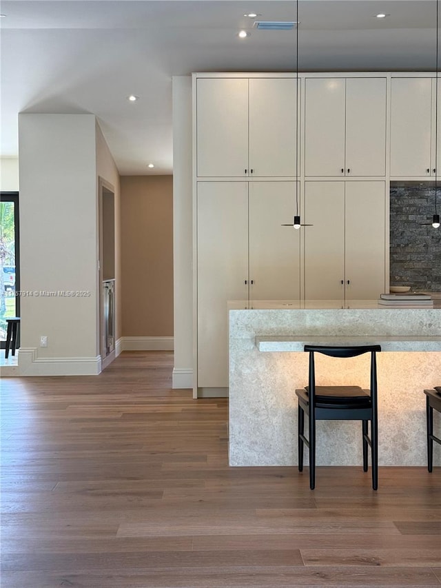 kitchen featuring recessed lighting, white cabinetry, and light wood finished floors