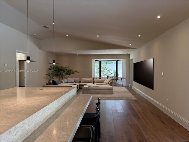 unfurnished living room with recessed lighting, visible vents, baseboards, vaulted ceiling, and hardwood / wood-style floors