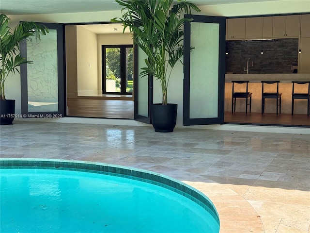 view of swimming pool featuring a sink