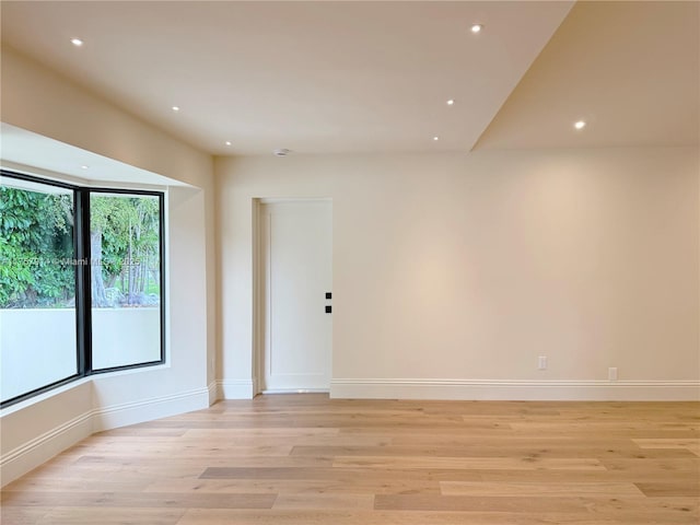 spare room featuring baseboards, light wood finished floors, and recessed lighting