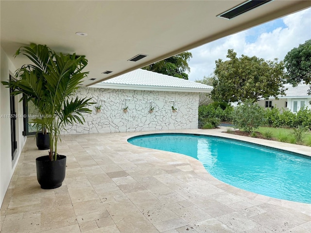 outdoor pool featuring a patio area