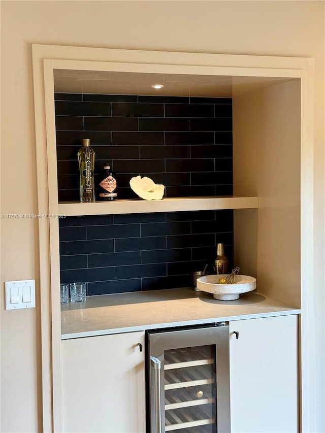 bar featuring a dry bar, beverage cooler, and tasteful backsplash