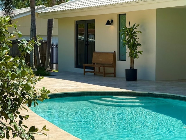 pool featuring a patio and fence