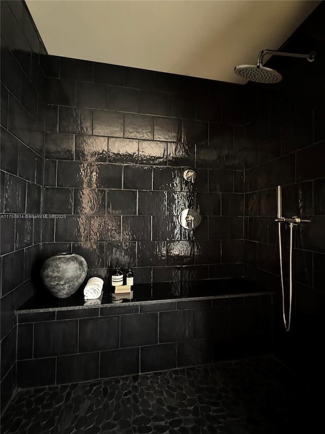 bathroom with tiled shower