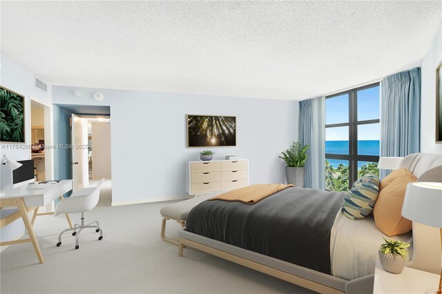 bedroom with a textured ceiling, carpet floors, a water view, visible vents, and floor to ceiling windows