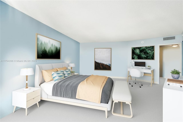 carpeted bedroom featuring visible vents