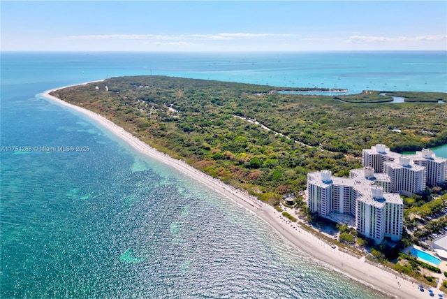 drone / aerial view featuring a view of the beach, a water view, and a city view