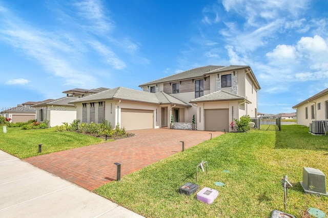 traditional-style house featuring a tiled roof, fence, cooling unit, decorative driveway, and a front lawn