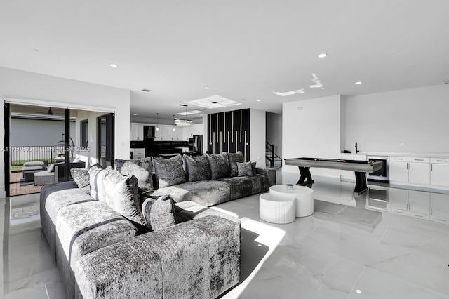 living room featuring recessed lighting, marble finish floor, and stairs