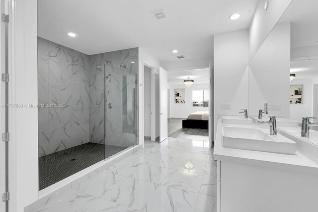 bathroom with a sink, marble finish floor, ensuite bath, and recessed lighting