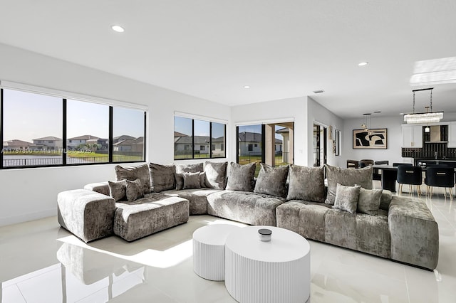 living area featuring light tile patterned floors and recessed lighting