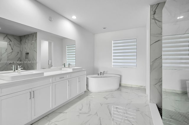 bathroom with double vanity, marble finish floor, a marble finish shower, and a sink