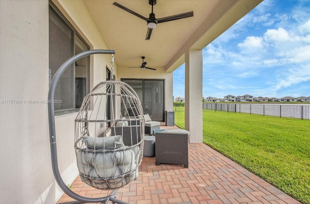 view of patio with fence and a ceiling fan