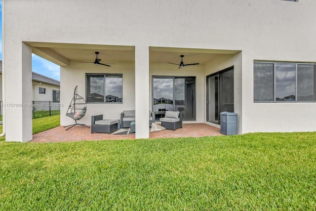 exterior space with a lawn, a patio area, and stucco siding