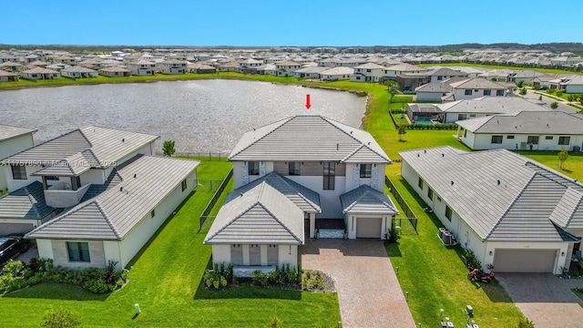 drone / aerial view featuring a water view and a residential view