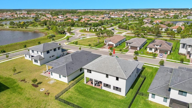 birds eye view of property with a water view and a residential view