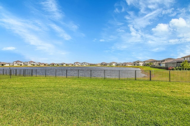 view of yard featuring a residential view and fence