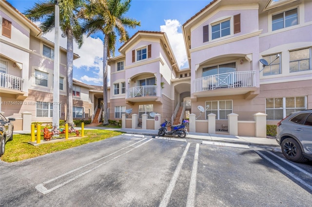 view of property featuring uncovered parking and a residential view