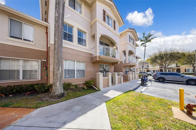 view of property with uncovered parking and a residential view