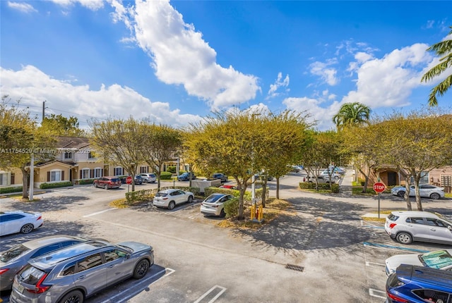 uncovered parking lot featuring a residential view