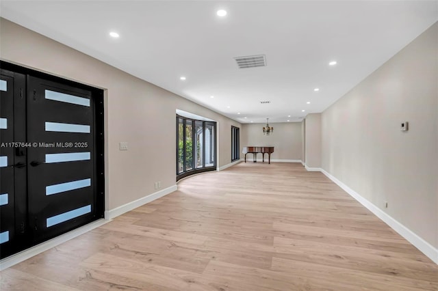 foyer with light wood-type flooring, visible vents, a notable chandelier, and recessed lighting