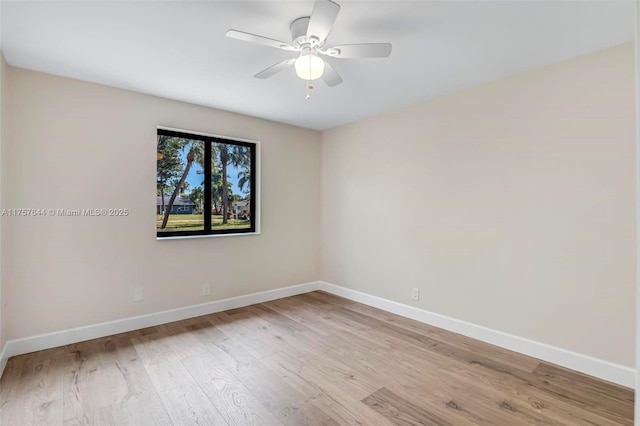 empty room with light wood-type flooring, ceiling fan, and baseboards