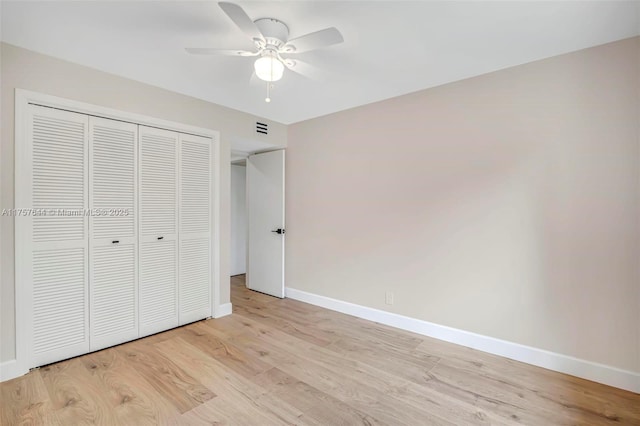 unfurnished bedroom with a closet, visible vents, light wood-style flooring, ceiling fan, and baseboards