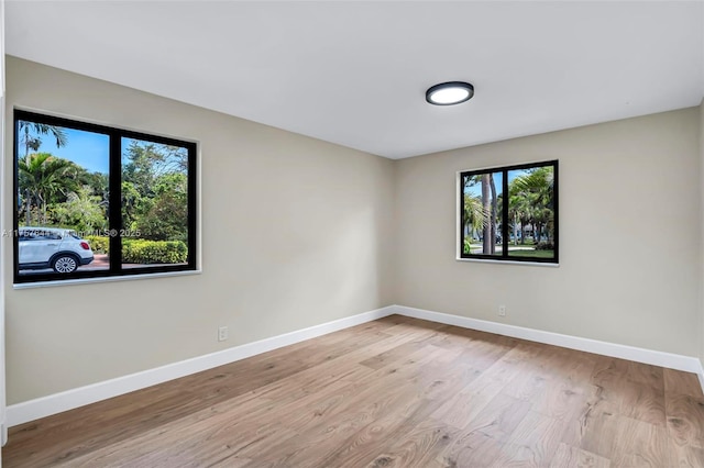 unfurnished room featuring wood finished floors and baseboards