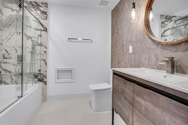 full bathroom featuring tile walls, visible vents, toilet, enclosed tub / shower combo, and vanity