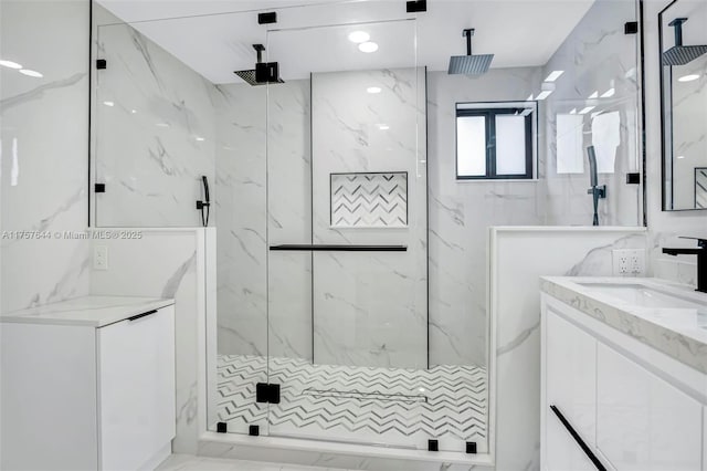 full bathroom featuring vanity and a marble finish shower