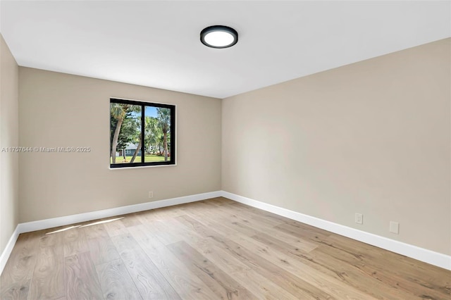 unfurnished room featuring wood finished floors and baseboards