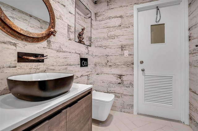 bathroom featuring toilet and vanity