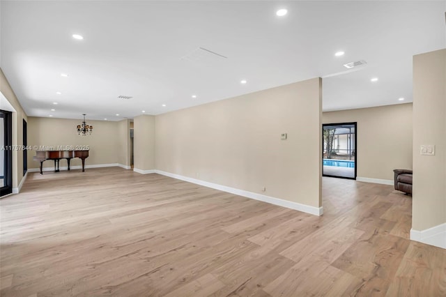 spare room with light wood-type flooring, baseboards, visible vents, and recessed lighting