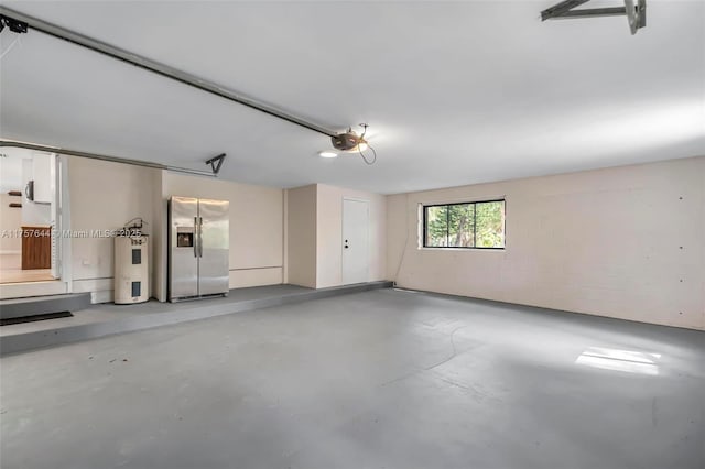 garage with a garage door opener, electric water heater, and stainless steel fridge with ice dispenser