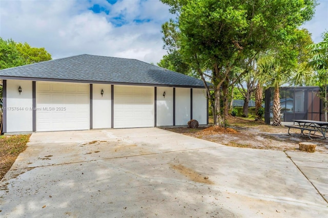 garage featuring concrete driveway