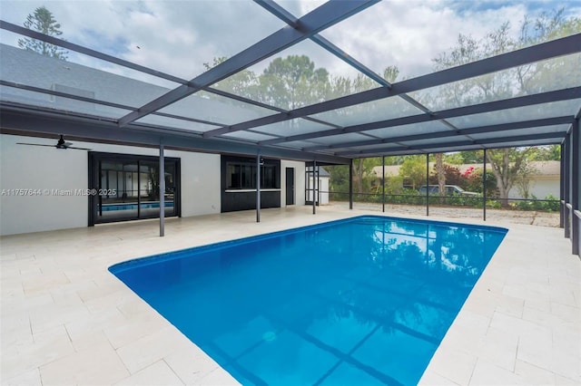 pool featuring glass enclosure and a patio