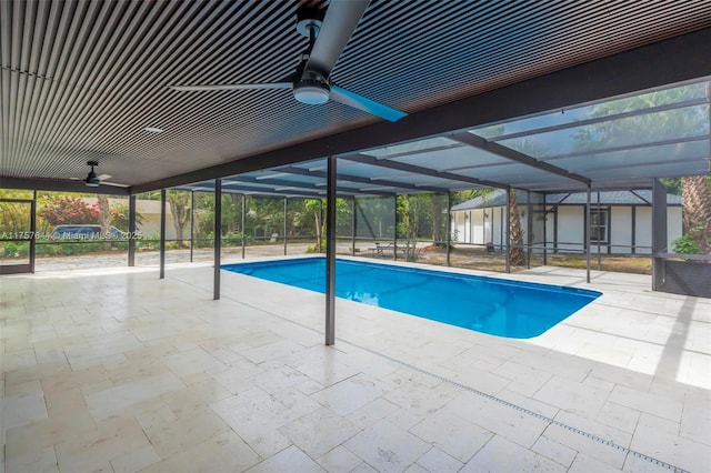 outdoor pool featuring ceiling fan, a patio area, and a lanai